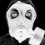 black and white negative representation of woman wearing gas mask and protective clothing