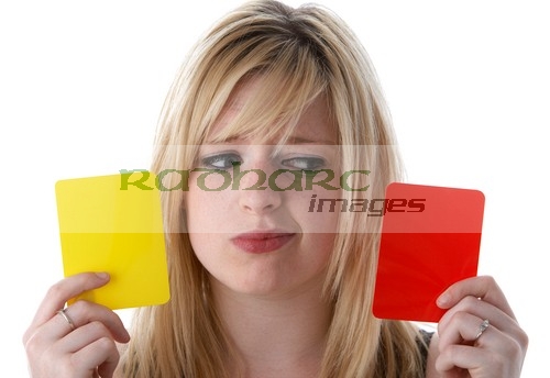 woman holding yellow and red cards
