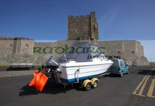 boat on trailer in front of carrickfergus castle