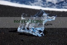 glacial iceberg fragment washed up on the black sand of jokulsarlon beach iceland
